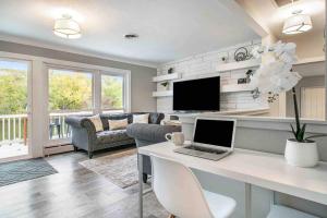 a living room with a desk with a laptop at Arrowhead Riverfront Kayaks/Patio 30 Min to ND! in Bristol