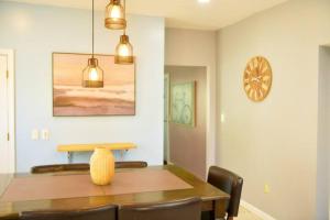 a dining room with a table and chairs and a clock at Cozy apartment 3rd 10min Walk Downtown and City View in Providence