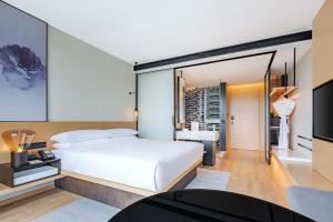 a bedroom with a large white bed and a tv at Fairfield by Marriott Beijing Daxing Airport in Beijing