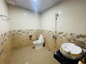 a bathroom with a toilet and a shower and a sink at Old Quarter Hanoi Autumn House in Hanoi