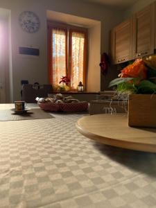 a kitchen with a table with a surfboard on the floor at Piccolo Borgo in Negrar