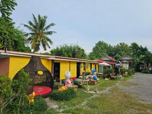 a group of people sitting outside of a house at Bansuan Inthanon Eco Resort in Chom Thong