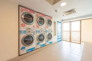 a row of washing machines in a laundry room at SunwayLagoonFamilySuite-2pax-Netflix-Balcony-Super Fast Internet in Petaling Jaya