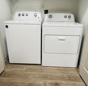two white appliances sitting next to each other in a kitchen at Peaceful apartment in Frisco