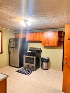 a kitchen with a stove and a refrigerator at Luxury apartments In Cheektowaga NY in Cheektowaga