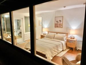 a bedroom with a bed and a large window at The Outpost Joshua Tree: Hot Tub, GameRoom, JTNP in Joshua Tree