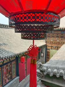 a red chandelier in front of a building at Pingyao hu lu wa Home Inn in Pingyao