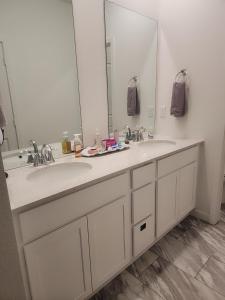a bathroom with two sinks and a large mirror at Cozy, Quiet Shared Room & Home in Watkins