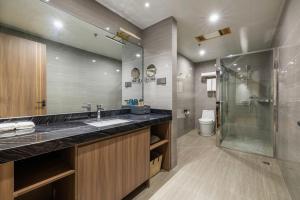 a bathroom with a large sink and a shower at Citadines Zhengda Mall Hefei in Hefei