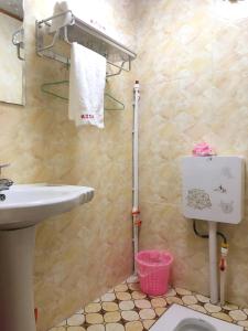 a bathroom with a sink and a toilet at Zhuji Inn in Xinduqiao