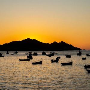 a group of boats in the water at sunset at Nolana hotel in Taltal
