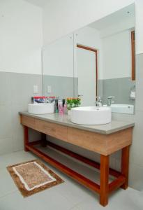 a bathroom with a sink and a mirror at Brand New Condo Apartment in Kampala