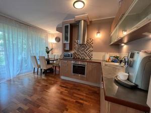a kitchen with a counter and a dining room with a table at Holiday house with sauna and garden, Pobierowo in Pobierowo