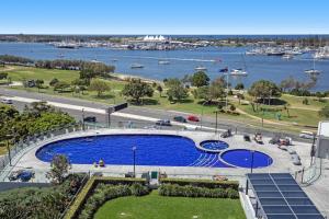 a large swimming pool with a view of the water at Como Prestige Breathtaking Southport Sundale in Gold Coast