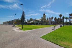 a park with a building with a clock tower at Beachtown Breeze - A Coastal Gem in Glenelg East in Glenelg