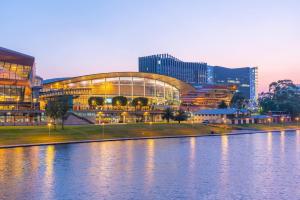 a large building next to a body of water at Stellar - Spacious Rooftop Dreamscape in Adelaide in Rose Park