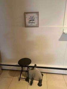 a chair sitting in a room with a white wall at Beautiful two bedroom apartment. in Calgary