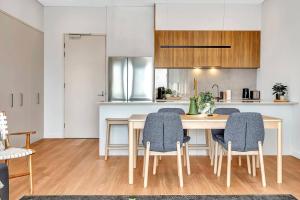 a kitchen and dining room with a table and chairs at 'The Outlook' Light-filled Nordic Contemporary in Glenunga