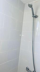 y baño con cabina de ducha con cabezal de ducha. en Cómodo apartamento en Santiago, en Licey al Medio