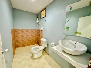 a bathroom with a white toilet and a sink at Relax Camp Resort Kaeng Krachan in Kaeng Krachan