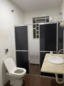 a bathroom with a toilet and a sink at Casa em Freguesia (Jacarepaguá) in Rio de Janeiro