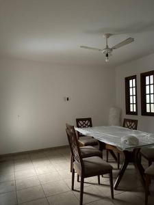 a dining room with a table and chairs at Casa em Freguesia (Jacarepaguá) in Rio de Janeiro