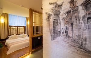 a room with a wall with a painting on it at Zhangjiajie Yueting Eco Inn in Zhangjiajie