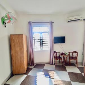 uma sala de estar com uma mesa e uma janela em Hoàng Nam - 617 Nguyễn Thị Định, Q2 - by Bay Hostel em Ho Chi Minh