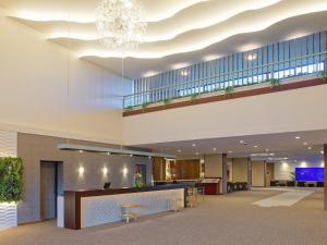 a lobby of a hospital with a chandelier at Yukai Resort Premium Shirahama Saichoraku in Shirahama