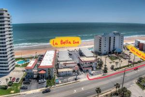 a building with a yellow sign on it next to the beach at *Beachfront Private Apartment*102* in Daytona Beach