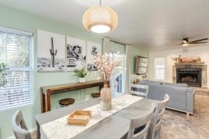 a dining room and living room with a table and chairs at Desert Sage House, Pool, 75in TV, Kids Living Area in Tucson