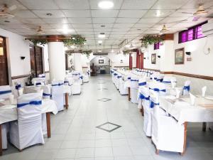 a row of tables and chairs in a dining room at Hotel Supreme in Sylhet