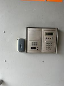 a microwave and a speaker on a wall at Manukau Studio Apartments in Auckland