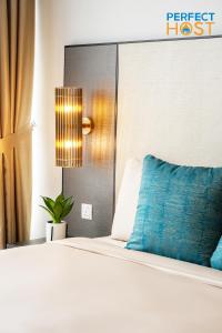a bedroom with a bed with a blue pillow at Pavilion Ceylon Hill Suites, Bukit Bintang in Kuala Lumpur