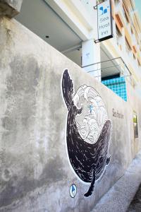 a mural of a whale painted on a wall at Kata Sea Host in Kata Beach