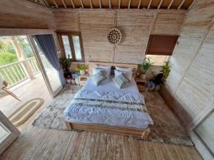 a bedroom with a large bed in a room at Garden Terrace Bali in Gobleg