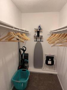 a walk in closet with a basket on the floor at 6 min to UT Southwestern_Fast Wi-fi in Dallas