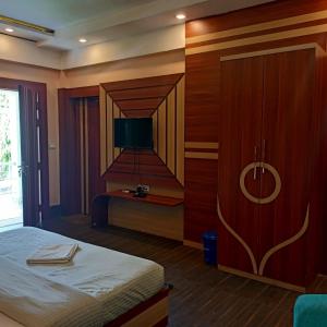 a bedroom with a bed and a staircase in it at Patkai Resort in Tinsukia