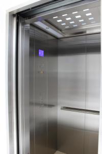 a elevator in a building with a sign on it at Heaven By O in Unawatuna