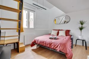 1 dormitorio con 1 cama con edredón rojo en Studio mezzanine 3-4 pers tout équipé Paris WIFI - R9 en Montreuil
