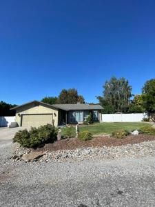 a house with a gravel driveway in front of it at Charming 3 Bedroom home with chimney & RV parking in East Wenatchee