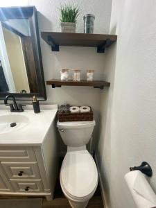a bathroom with a white toilet and a sink at Charming 3 Bedroom home with chimney & RV parking in East Wenatchee