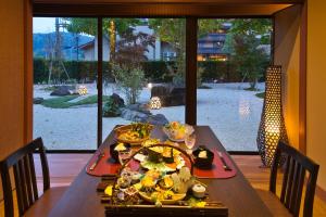 a table with a plate of food on it at Kanazawa Hyakurakusou in Kanazawa