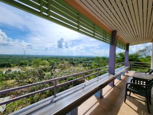 a balcony with a view of the forest at Baan Khao Noi Resort in Surat Thani