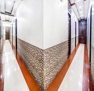 a hallway of a building with a tile wall at FabHotel The Adore Palace in Mumbai