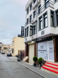 a building with a sign for a sushi hotel on a street at Stylish Hotel Old City in Istanbul