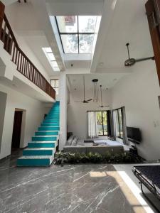 a room with a staircase with a blue stair case at Palm 3Bhk Villa Alibaug in Alībāg