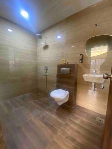 a bathroom with a toilet and a sink at Palm 3Bhk Villa Alibaug in Alībāg