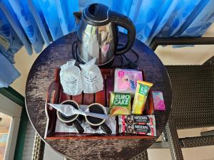 a table with a tray with a tea pot and scissors at Baan Khao Noi Resort in Surat Thani
