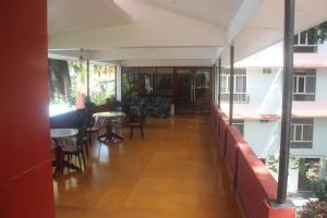 a corridor of a restaurant with tables and chairs at Hotel Serene Palace in Port Blair